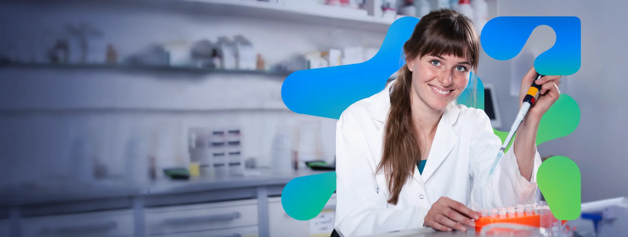 Smiling scientist holding syringe
