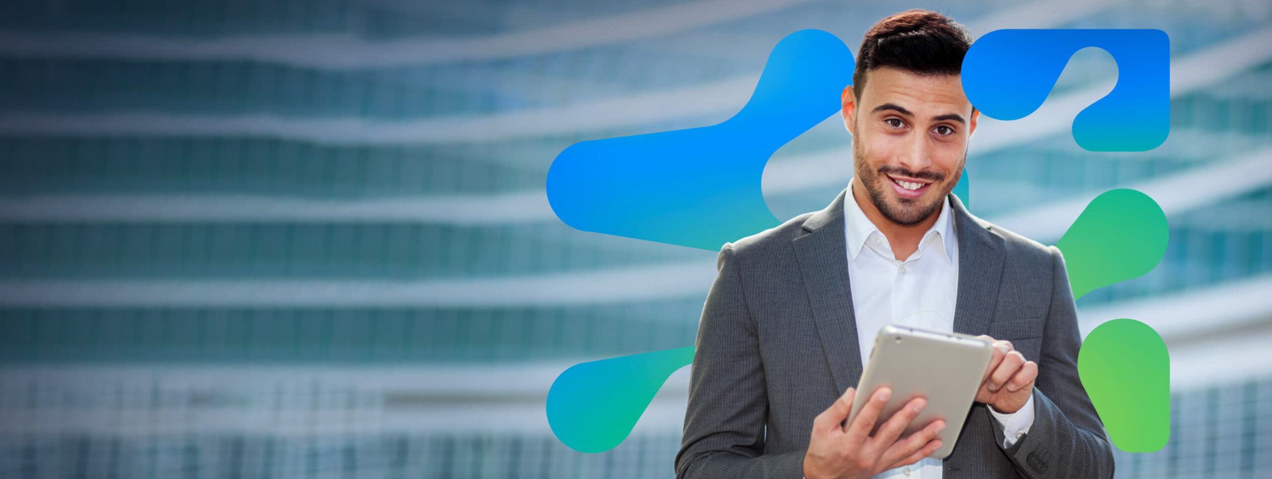 A man in a suit, holding a tablet device