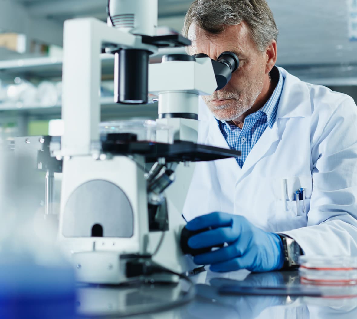 Male scientist using microscope