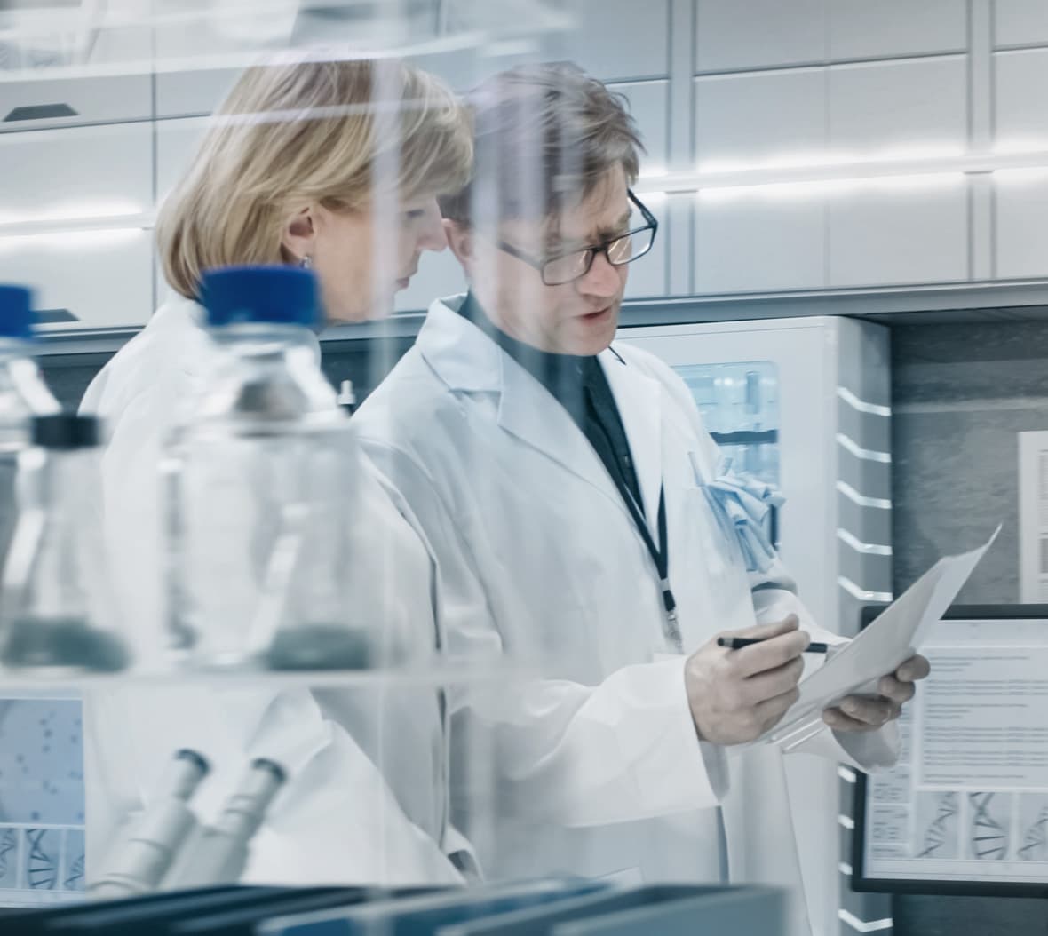 Two scientists talking over laminated paper