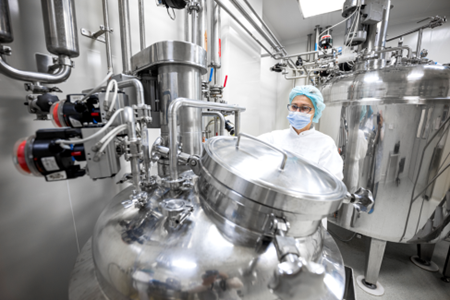 Laboratory worker in GBI's biologics CDMO manufacturing facility.