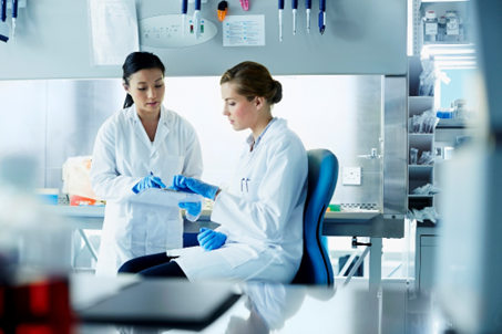 Photo of scientists in GBI's biologics laboratory working together.