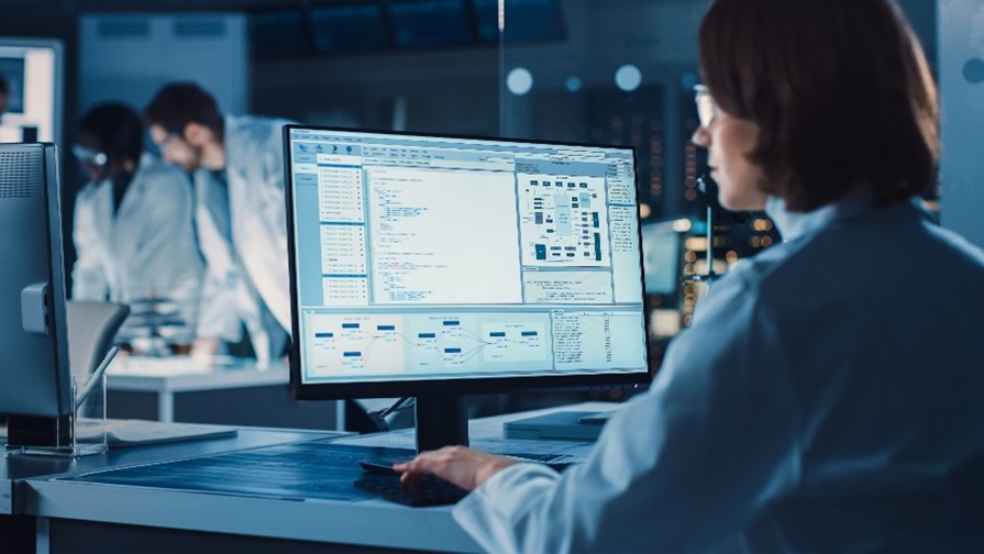 A person working in a biotech CDMO facility on a computer